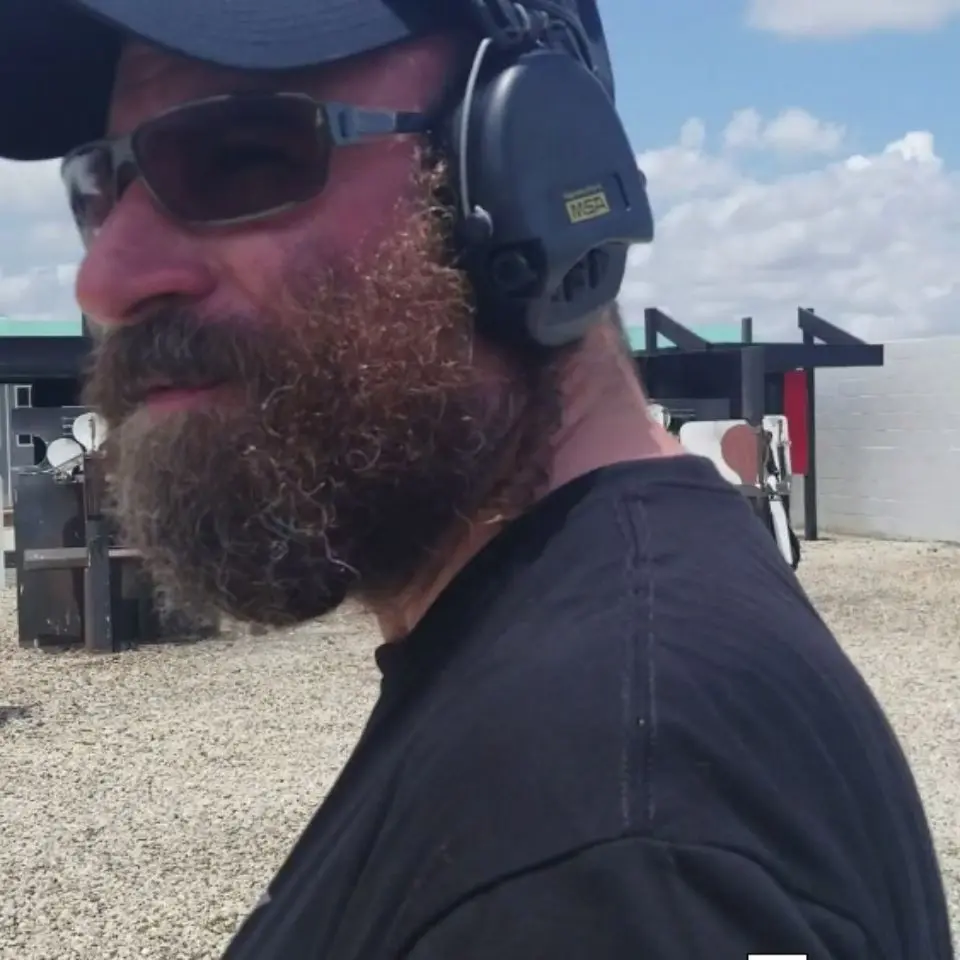 A man with beard and headphones on.